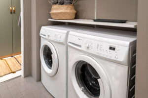 White laundry machines installed in the bathroom